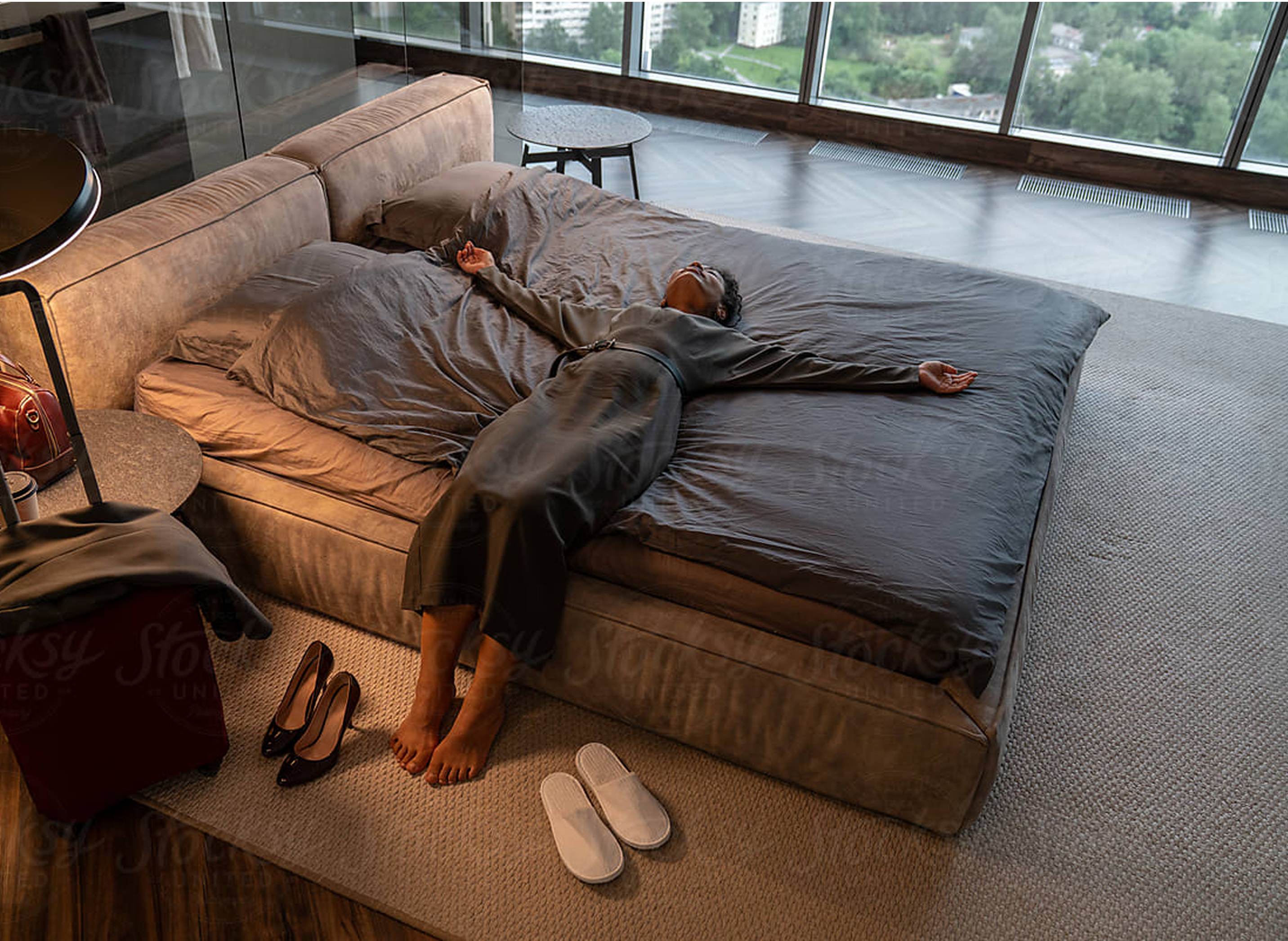 A woman laying on a hotel bed